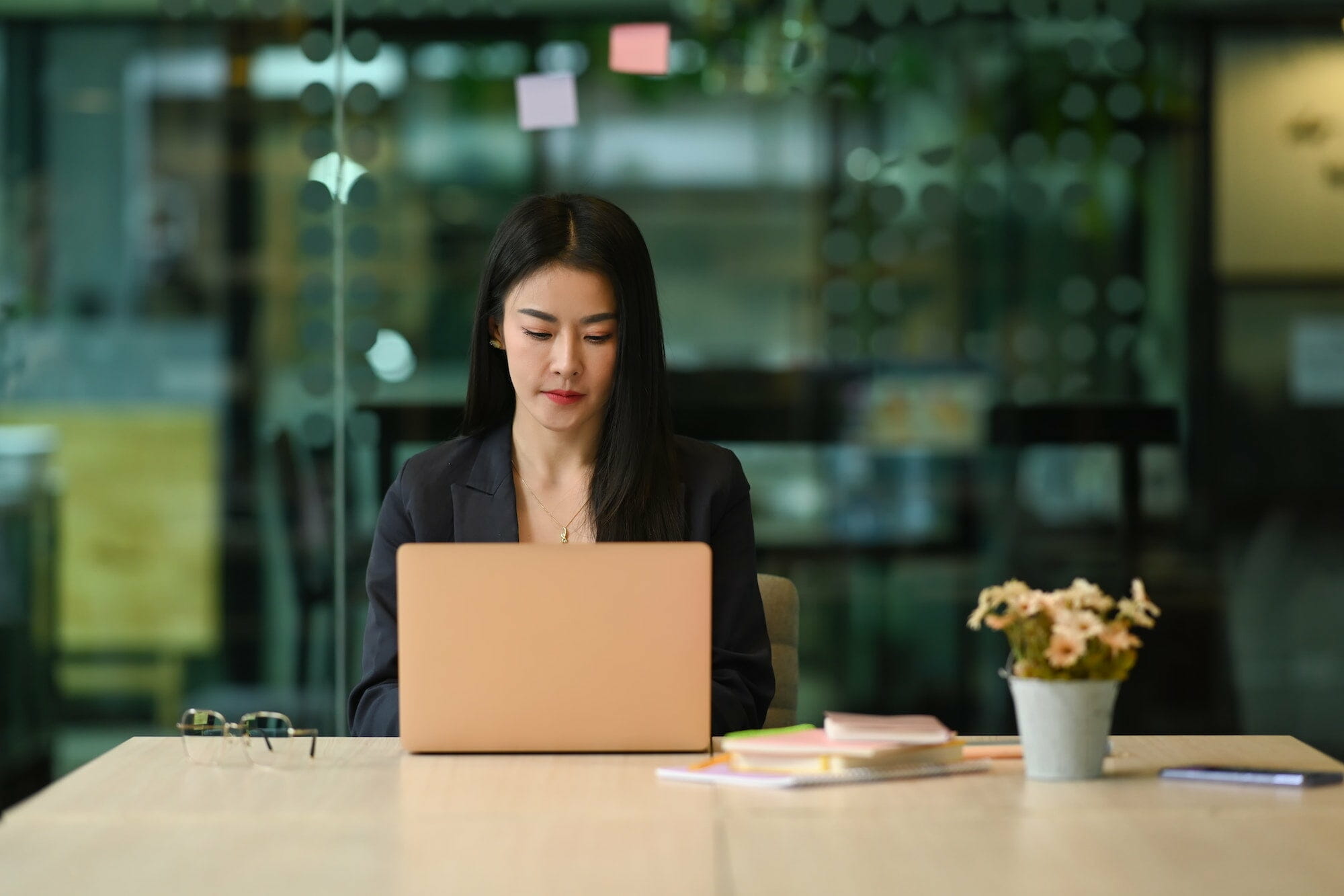 Millennial female entrepreneur typing business ecommerce email marketing, working online on her laptop computer.