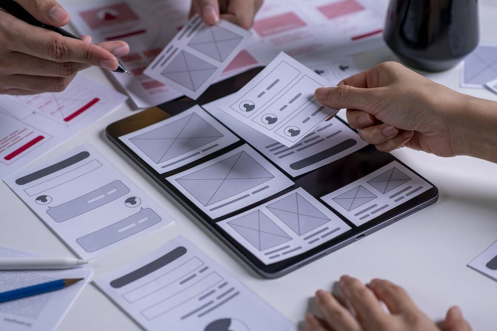 People from UI UX team arranging a responsive web design optimization