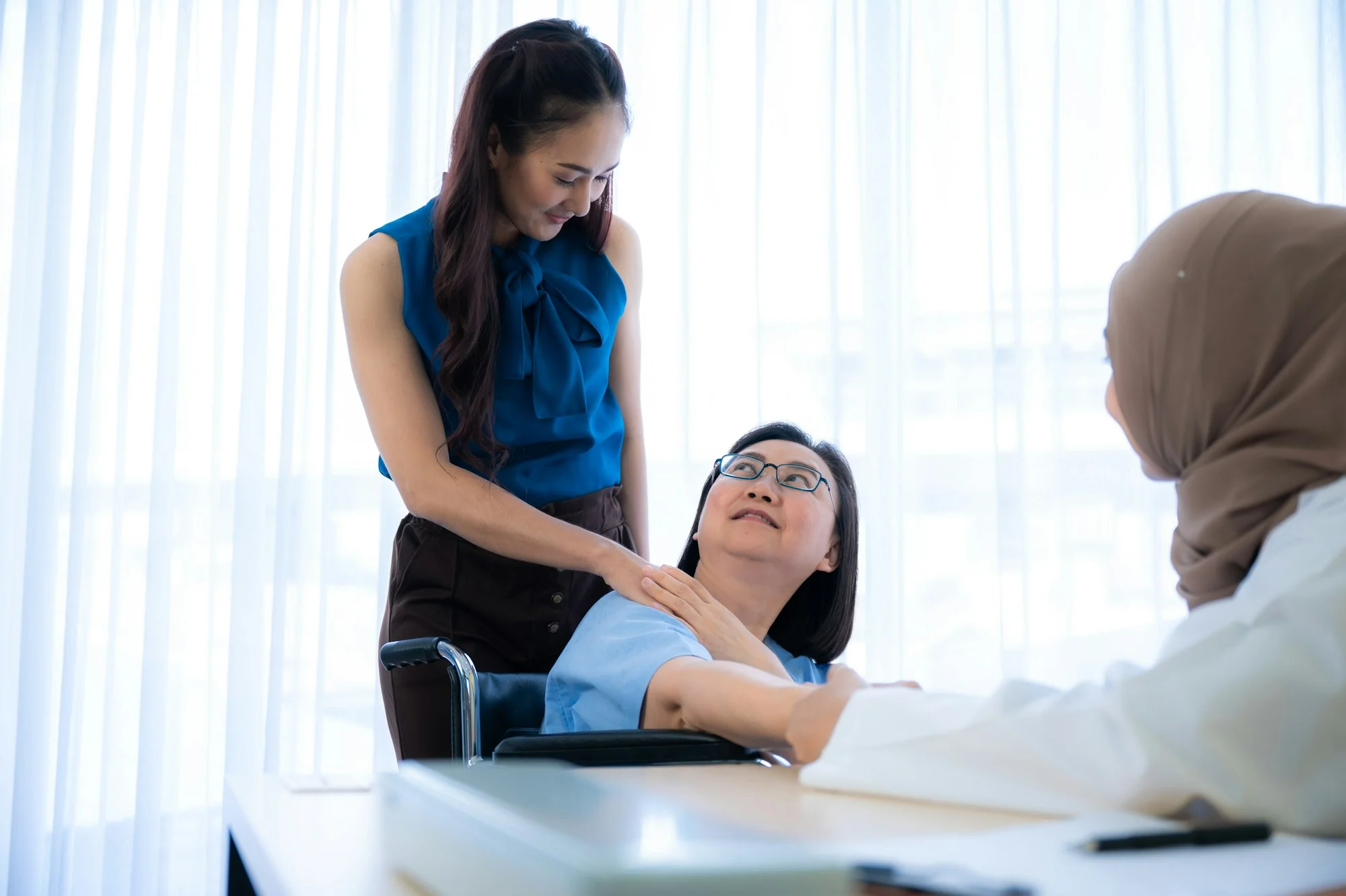 Senior female patient was exam and check up by the woman Muslim and Asian doctor at clinic