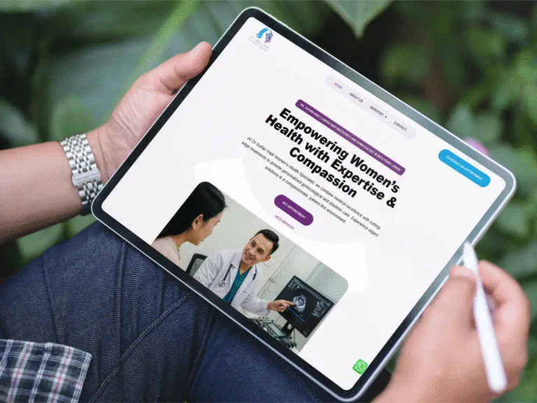 Woman holding a tablet displaying a healthcare website focused on women's health, featuring a doctor-patient consultation image.
