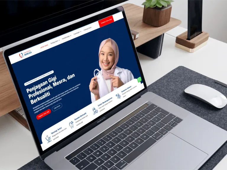Healthcare website displayed on a laptop, featuring a smiling female professional promoting dental services and patient care.